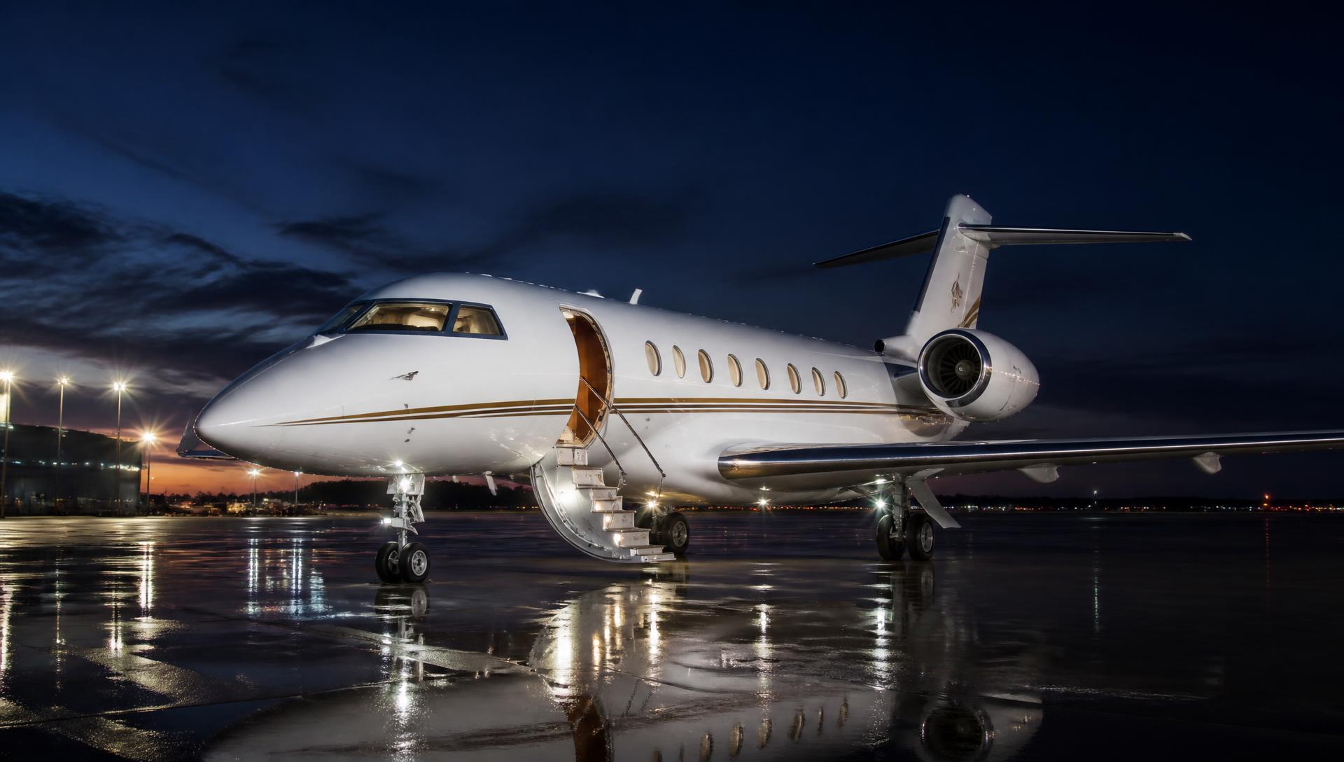 Private jet detailed and parked on a floodlit apron at dusk